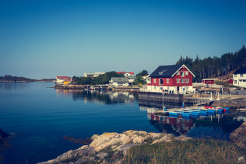 Fototapeta premium Sea cliffs and houses on the sea in Norway