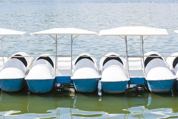 the row of white pedal boat on the lake