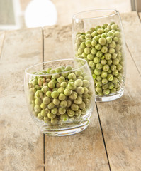 Frozen peas close up on wooden background