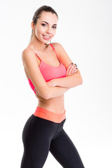 Fototapeta premium Cute lovely young fitness woman posing with folded hands