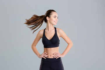 Positive cheerful fitness woman warming up and turning her head