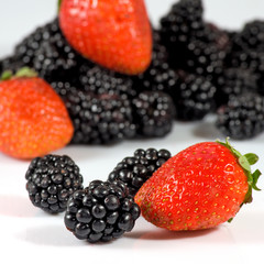 Isolated image of ripe blackberry and strawberry closeup