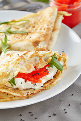 pancakes stuffed with a red caviar
