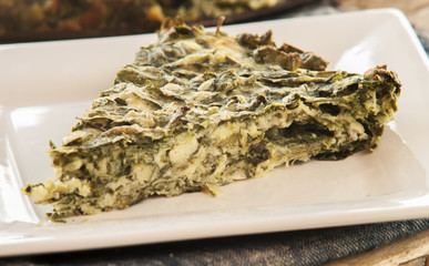 Spinach cake close up on white plate