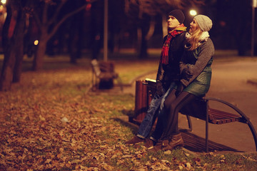 Naklejka premium couple walking in the autumn park young man and woman