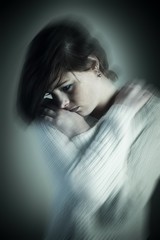 Composite image of sad brunette thinking with arms crossed