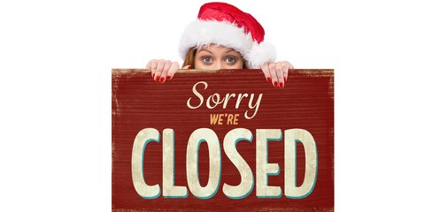 Festive woman holding closed sign