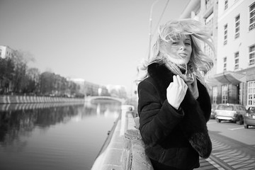 black and white portrait of a woman walking in the city