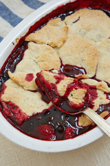a bowl of blueberry jam and pieces of pie in it
