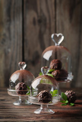 Chocolate sweets with nuts, mint and cacao on the vintage table