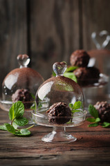 Chocolate sweets with nuts, mint and cacao on the vintage table