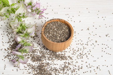 Chia seed healthy super food with flower over white wood backgro