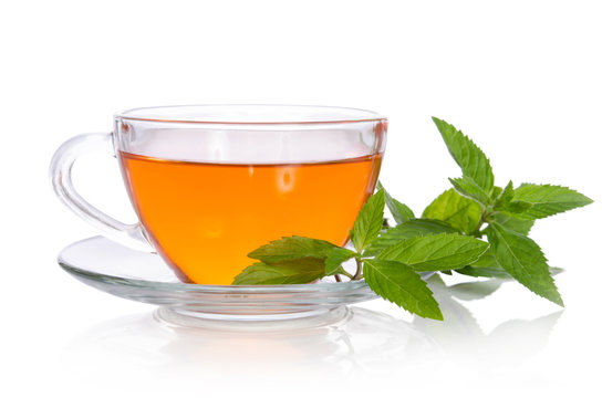 Glass cup of tea with mint on the white background