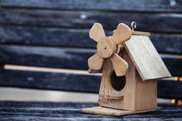 wooden bird house on grunge wooden panel