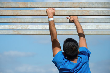 Mud race runners,hands overcome obstacle