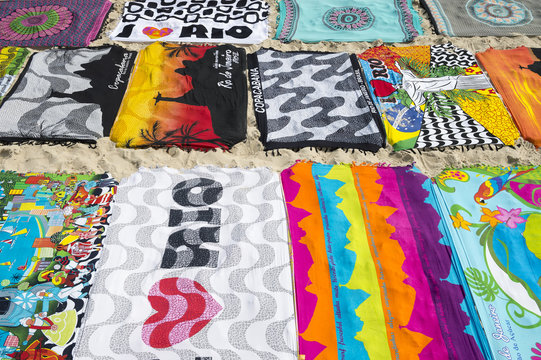 Beach blanket sarongs known locally as canga spread out in colorful display along the Ipanema Beach boardwalk