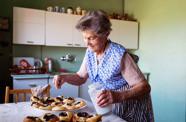 Fototapeta na wymiar Senior woman baking
