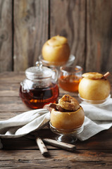 Baked apples with honey and cinnamon on the wooden table