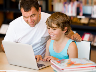 Little boy and his father with laptop