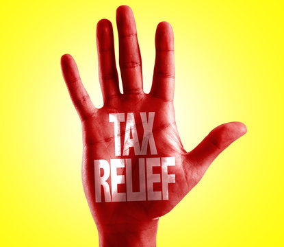 Tax Relief written on hand with yellow background
