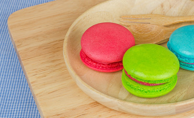 Tasty Sweet Macaroons on wooden background.