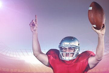 Composite image of american football player with arms raised