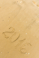 2016 Year written on the beach sand
