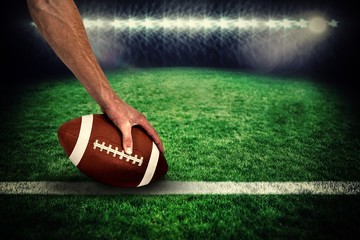 American football player placing ball