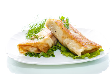fried stuffed spring rolls on a plate