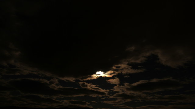 4k Moon Nighttime Time Lapse: Clouds passing by subsequently eclipsing the moon