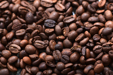 Closeup of roasted coffee beans pouring out
