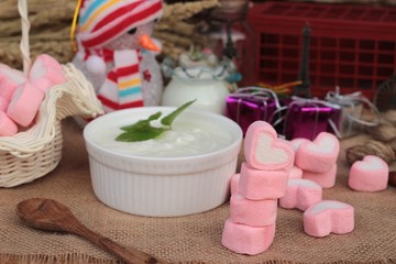 Heart pink marshmallow sweet with yogurt delicious.