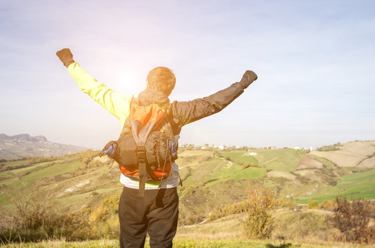 Hiking - Hiker holding his arms up as a sign of success and freedom