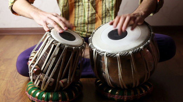 Man playing on Indian tabla drums 