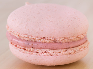 Close up Tasty Sweet Macaroon on wooden background.