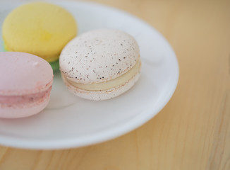 Closeup Cream macarons on wooden background.