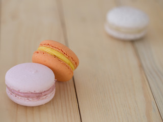 Closeup Orange  Macaroons on wooden background.