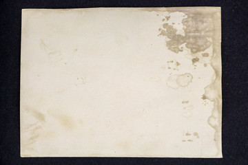Old grunge paper sheet, isolated on black background.