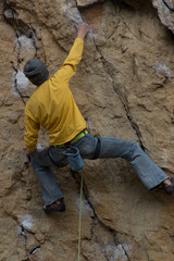 Young man on a difficult mountain route.