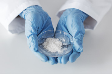 close up of scientist holding petri dish in lab