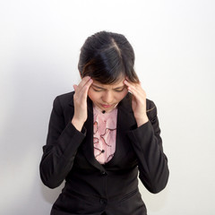 A woman with headache, migraine, stress, hangover in business ex