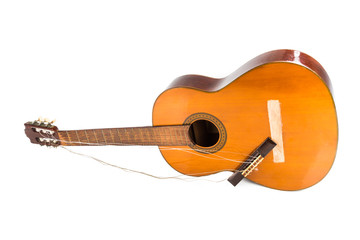 Broken brown classical guitar with detached bridge from body isolated in white background