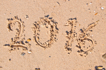 New Years 2016 concept; 2016 on the sand backgroung Texture