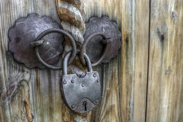 Old padlock on a wooden door