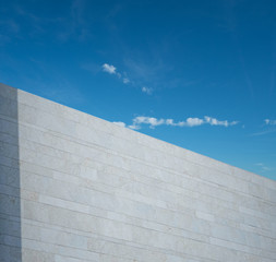 White marbled wall and blue sky with tree 