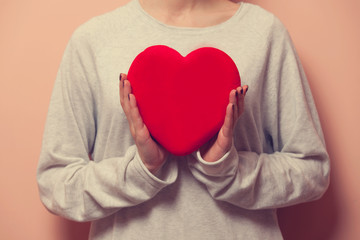 Woman holding heart shape toy