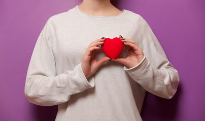 Woman holding heart shape toy