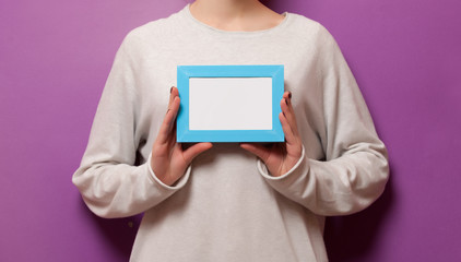 Woman holding a photo frame
