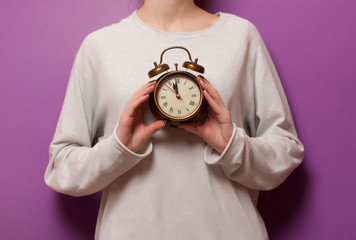 Woman holding clock