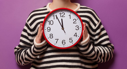 Woman holding clock